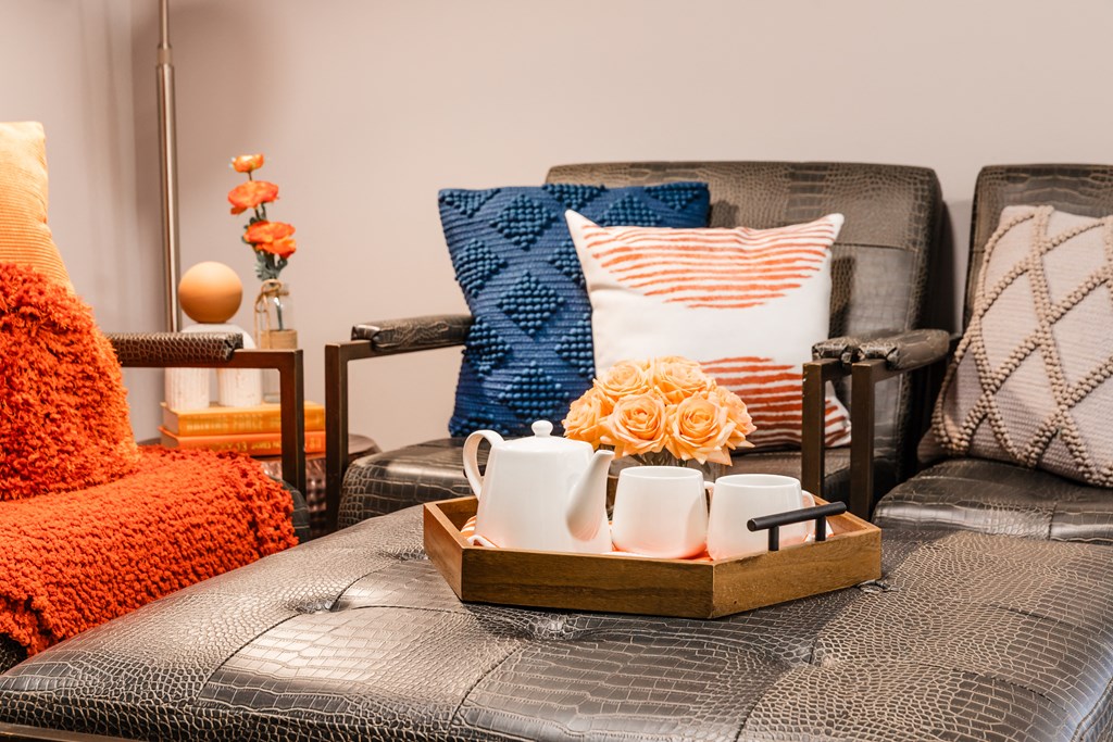 a living room with a couch and a tray with tea cups and flowers