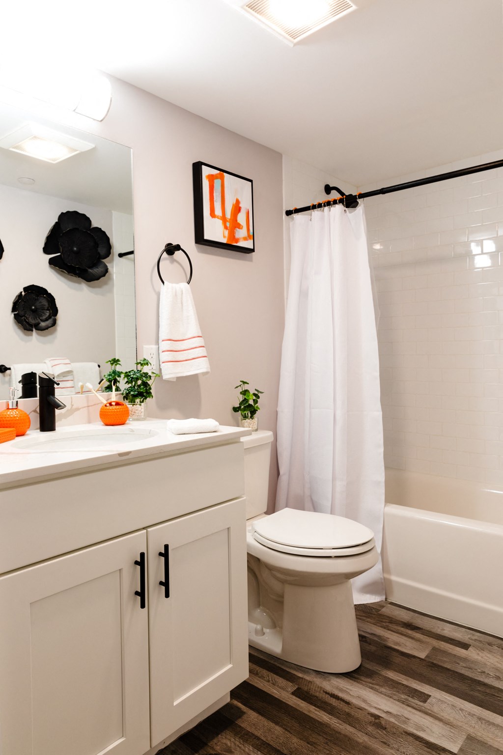 a bathroom with a toilet and a shower and a sink