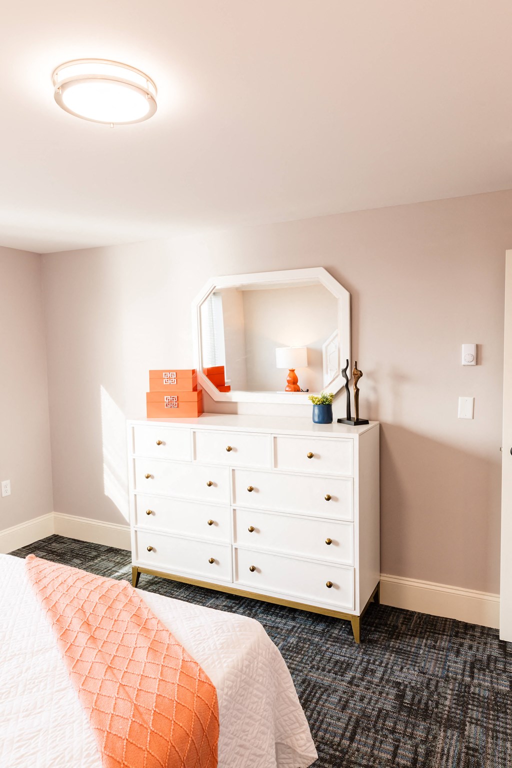 a dresser with a mirror on top of it in a bedroom