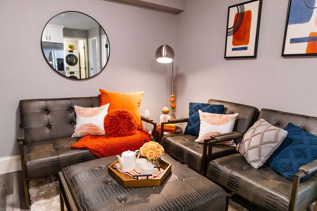 living room with couches and a coffee table and a mirror