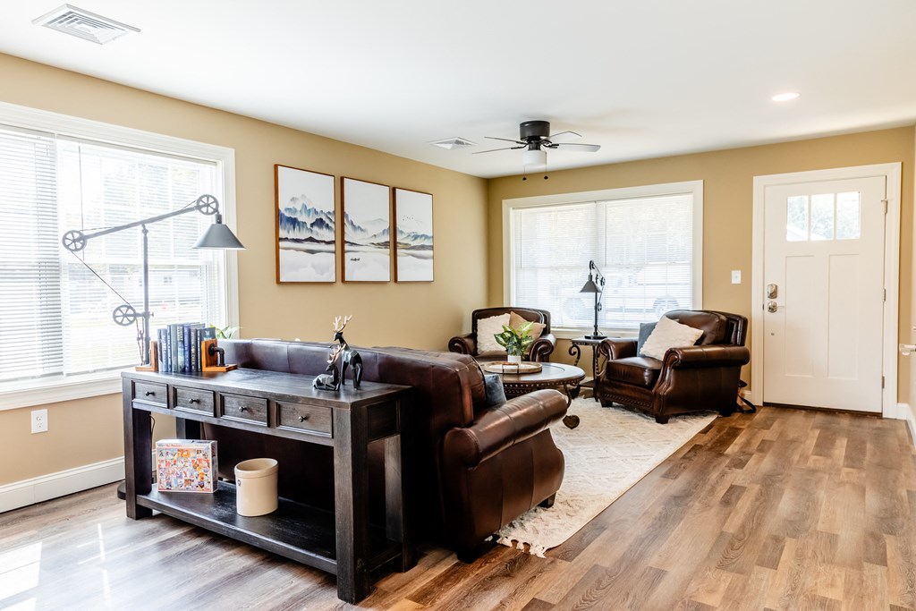 a living room with a couch and chairs and a table