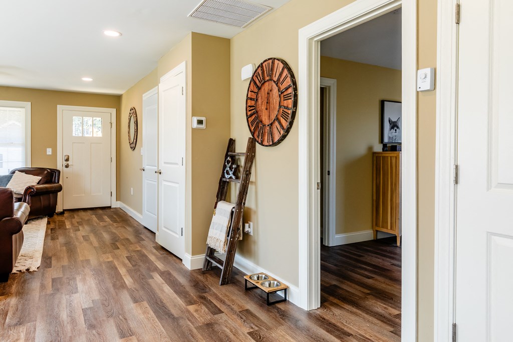 a living room with a ladder and a clock on the wall