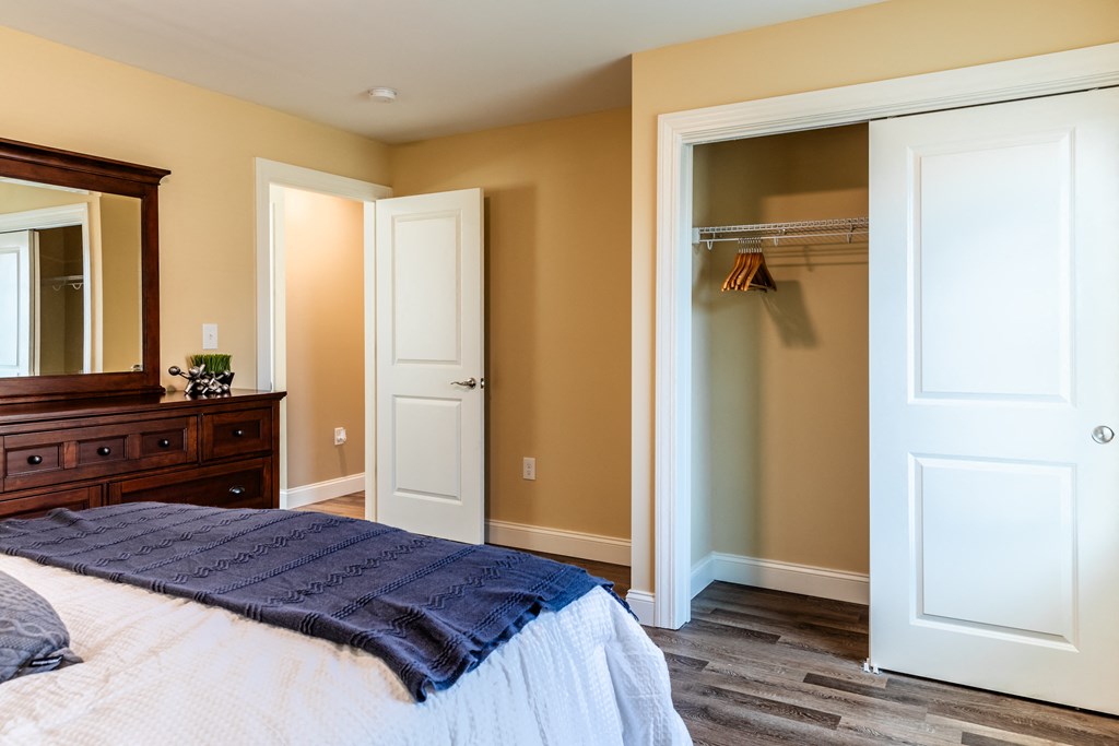 a bedroom with a bed and a closet and a mirror