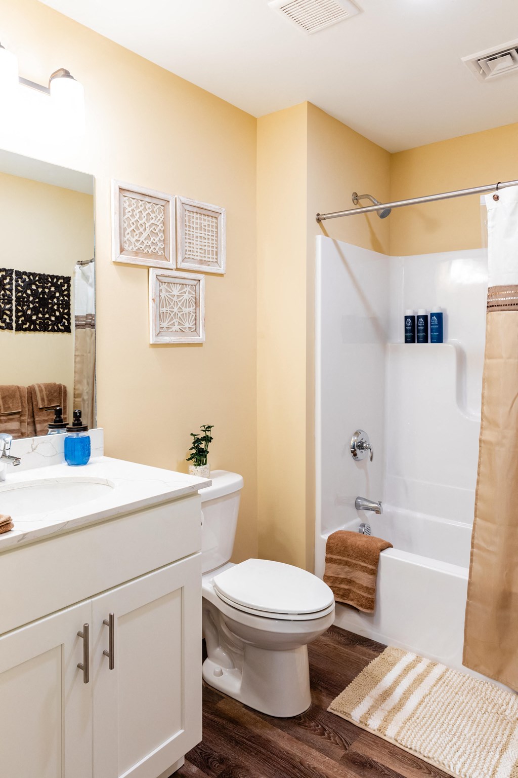 a bathroom with a shower and a sink and a toilet