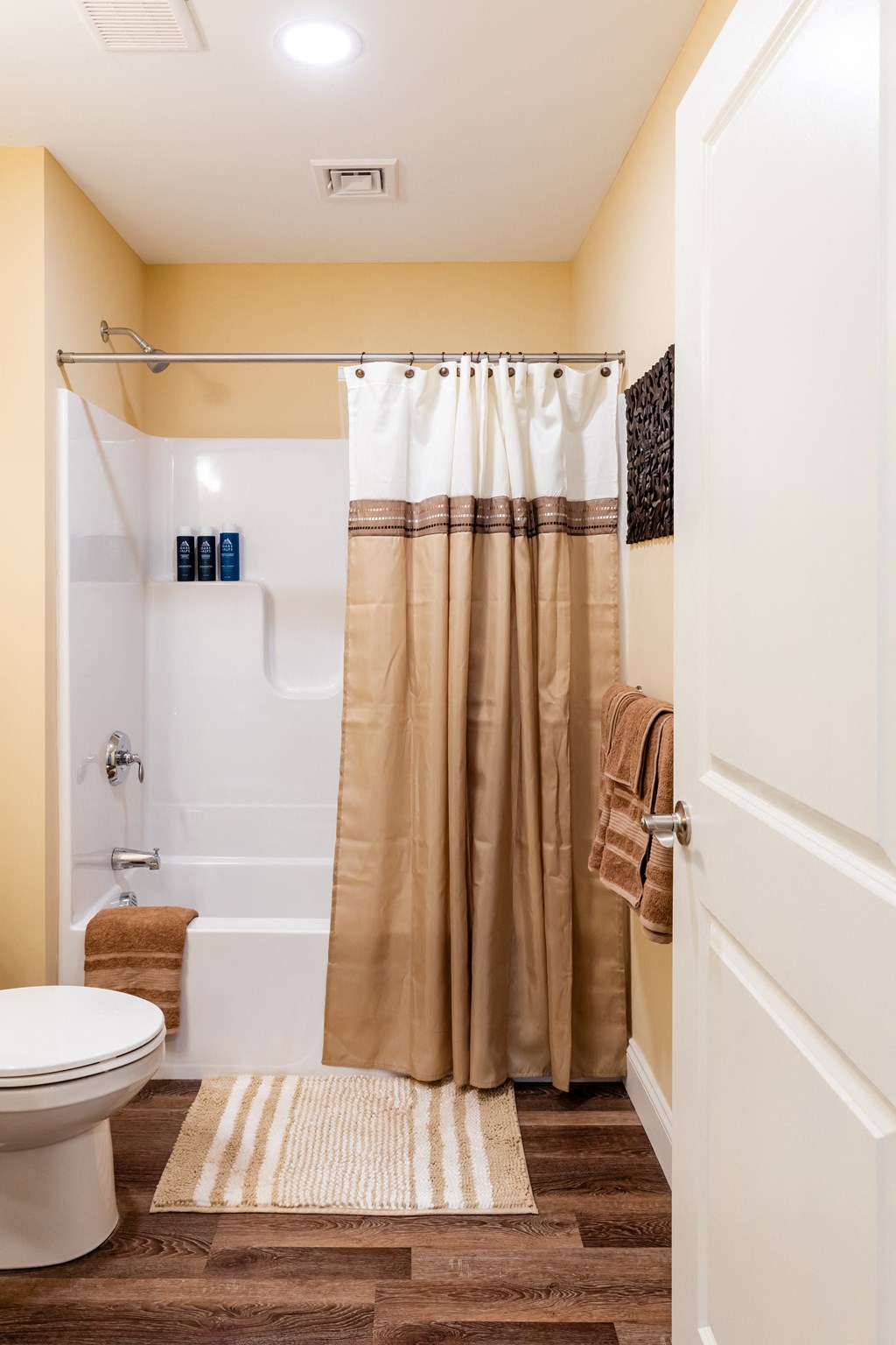 a bathroom with a toilet and a shower with a shower curtain