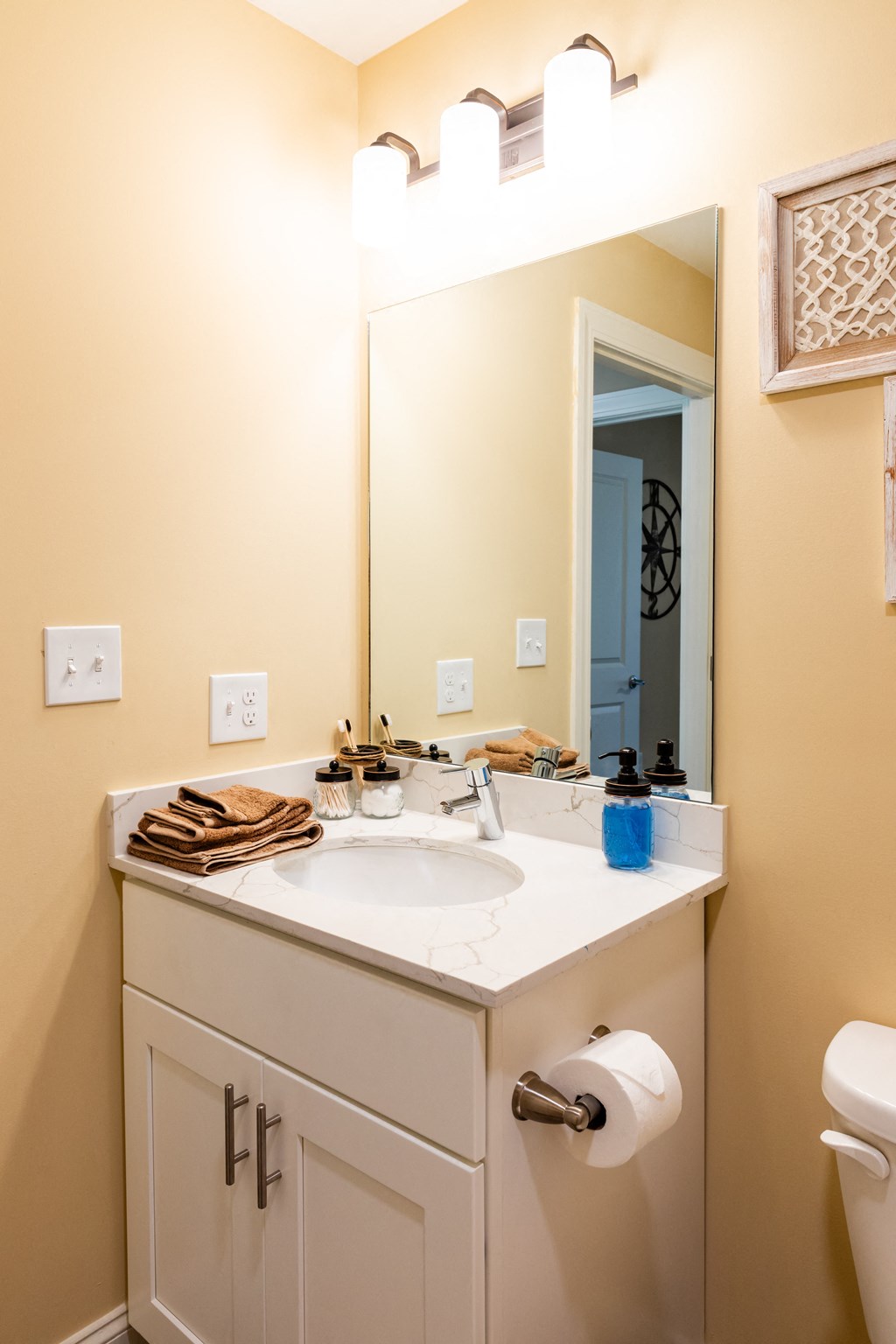 a bathroom with a sink and a mirror and a toilet
