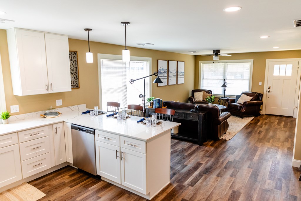 a kitchen with an island and a living room with a couch