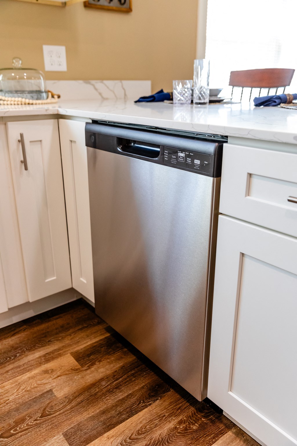 a stainless steel dishwasher in a white kitchen