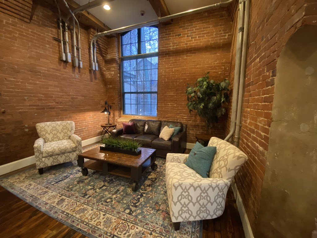 a living room with a couch and chairs and a table