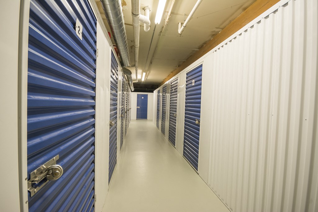 a view of a long hallway with blue and white lockers