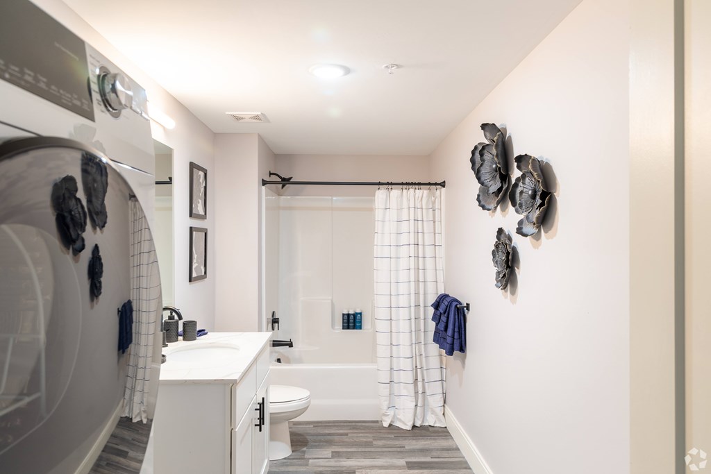 A bathroom with a white sink and a white toilet.