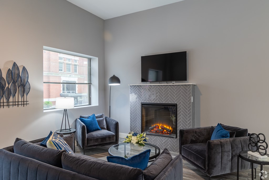 A living room with a fireplace and a television.