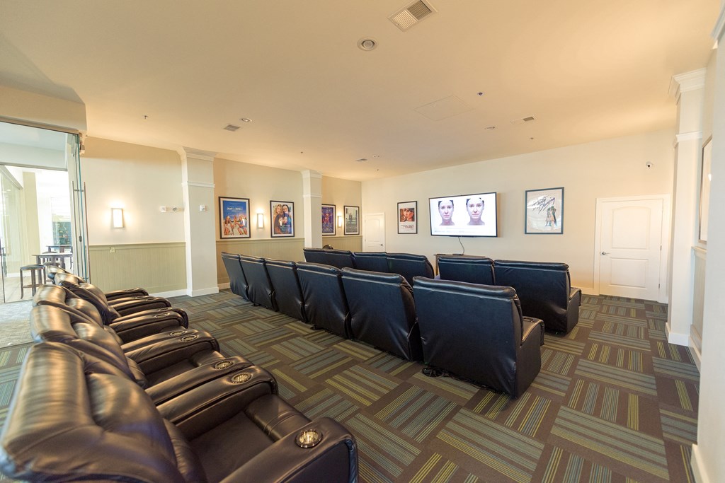 a large living room with leather couches and chairs