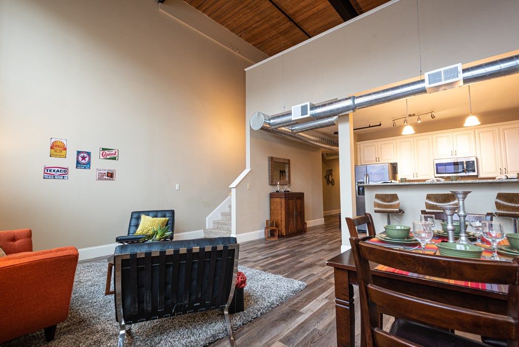 a living room with a dining room table and a kitchen