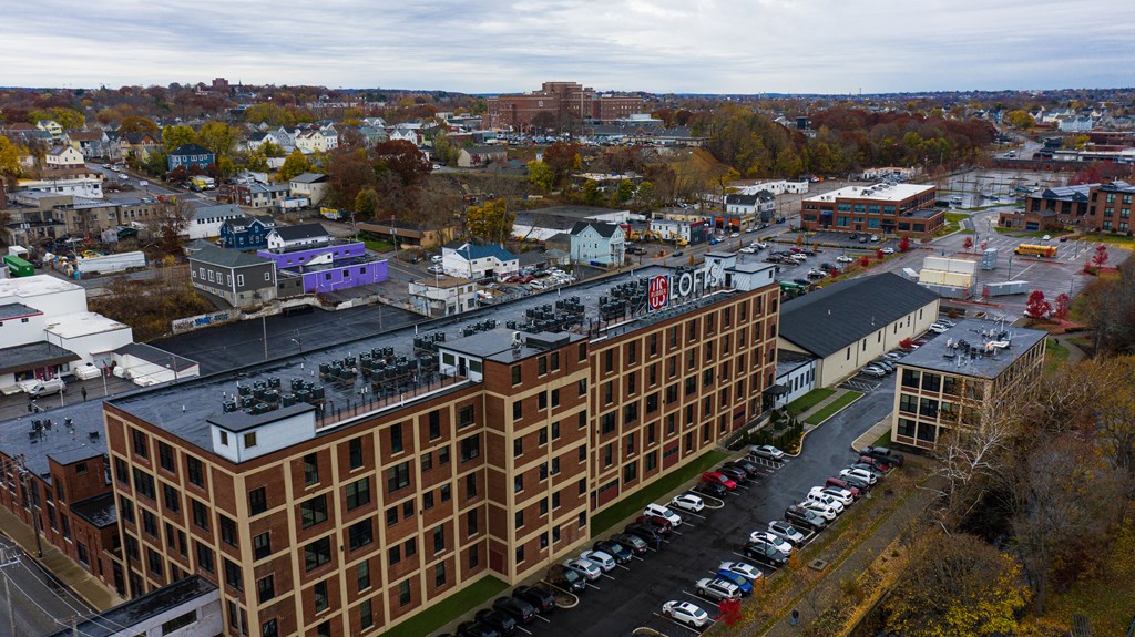 an aerial view of a large brick building in a city