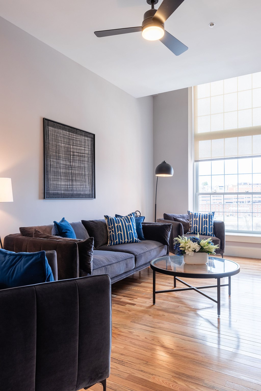 A living room with a couch, chairs, and a coffee table.