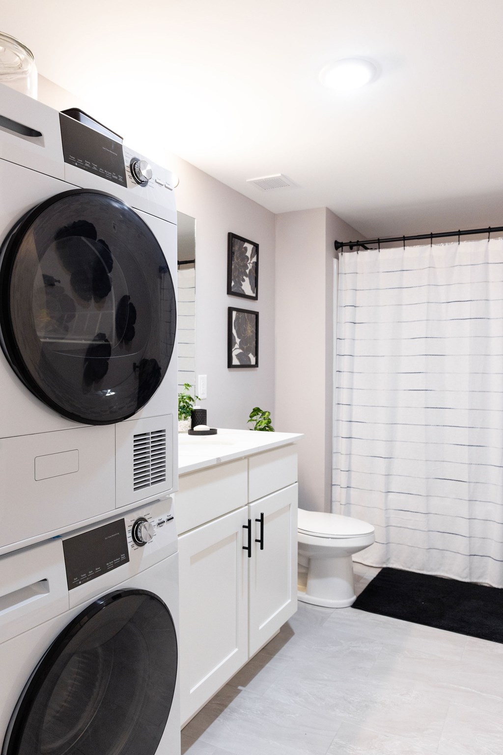 A white washing machine and dryer in a small laundry room.