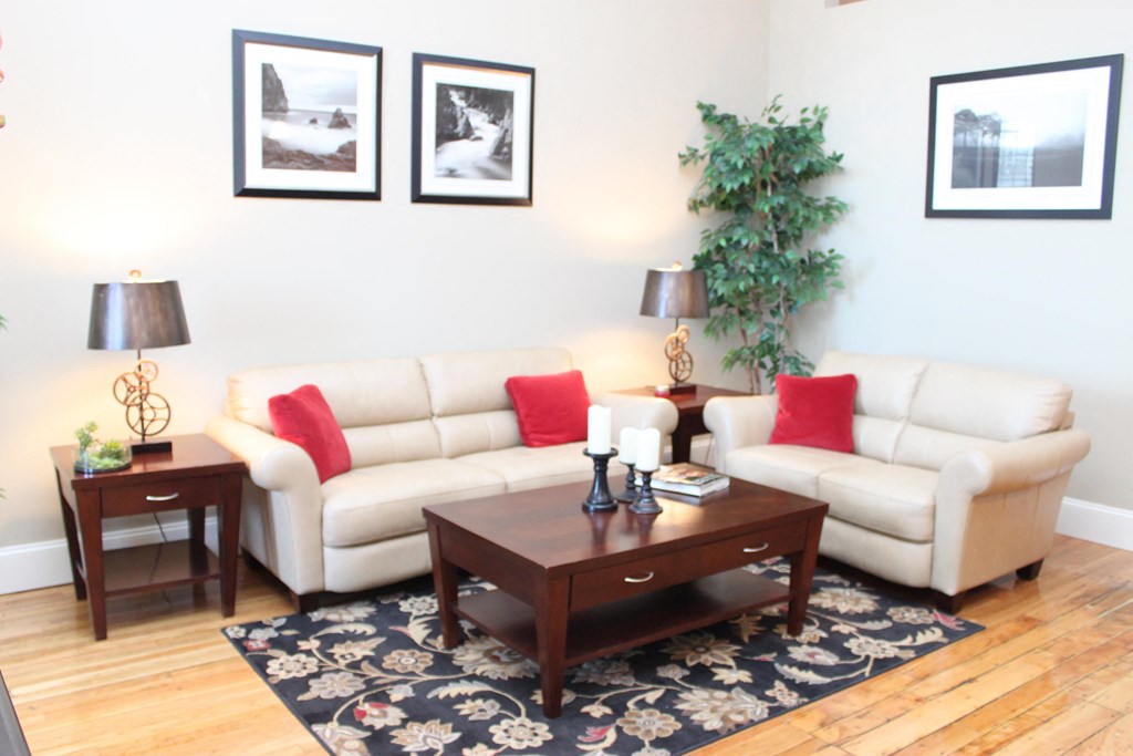 a living room with white couches and a coffee table
