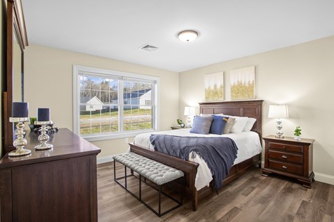 a bedroom with a large bed and a window