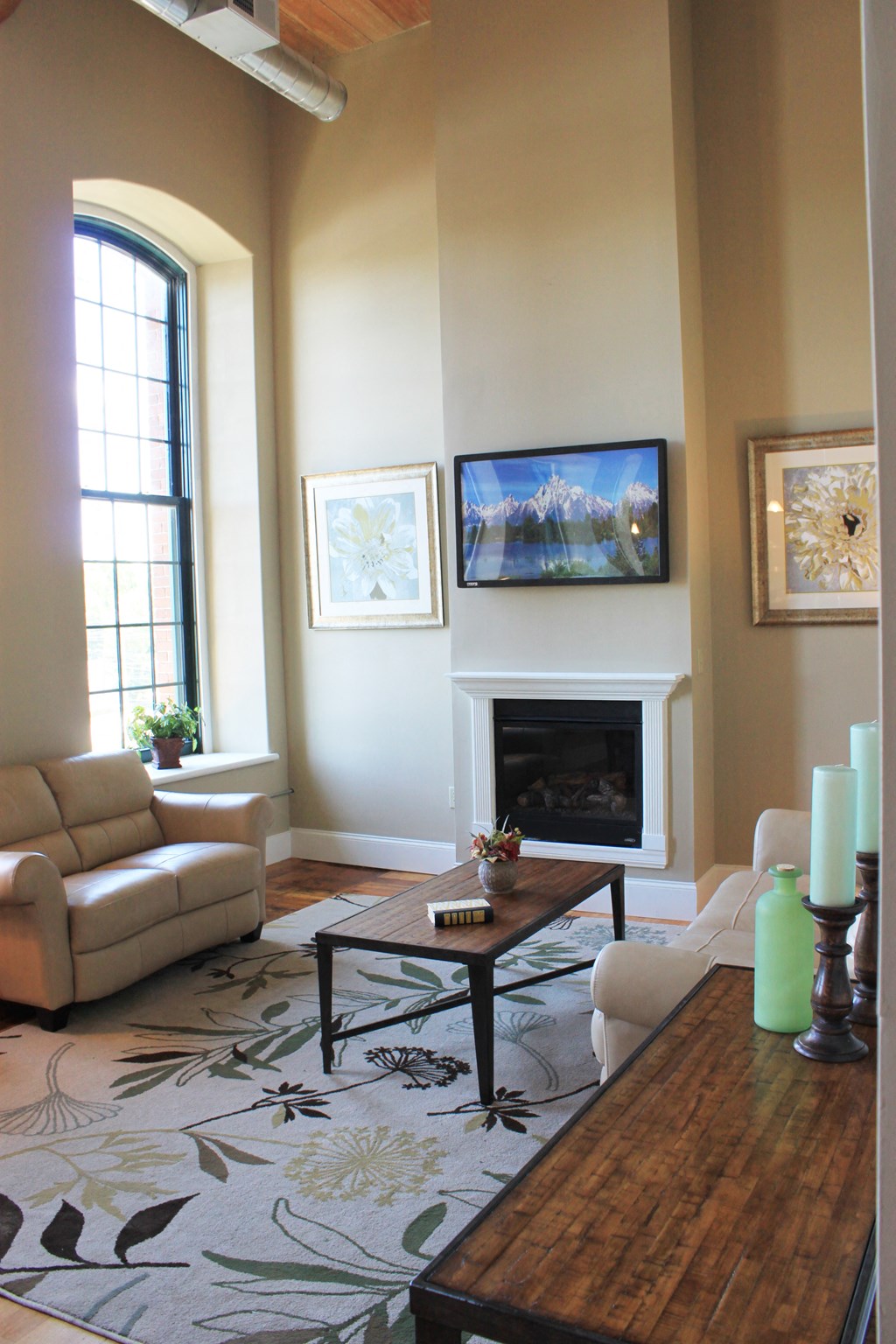 a living room with a couch and a table and a fireplace