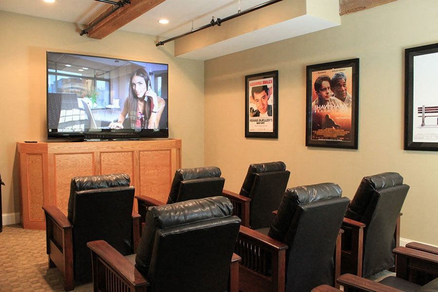 a living room with leather chairs and a tv