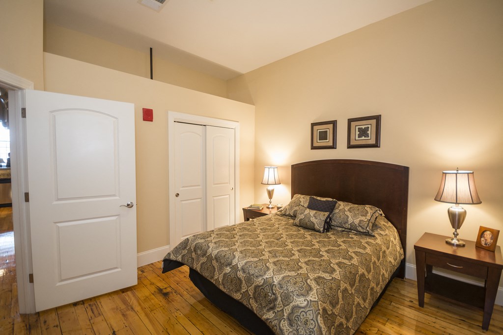 a bedroom with a bed and two doors