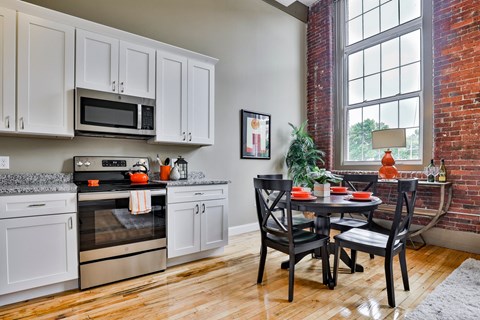 an open kitchen and dining room with a table and chairs