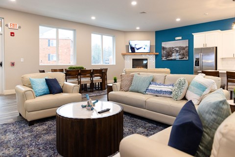 A living room with a couch, chairs, and a coffee table.