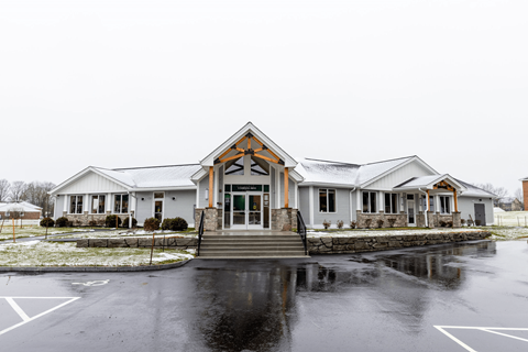 A church with a white building and a black parking lot.