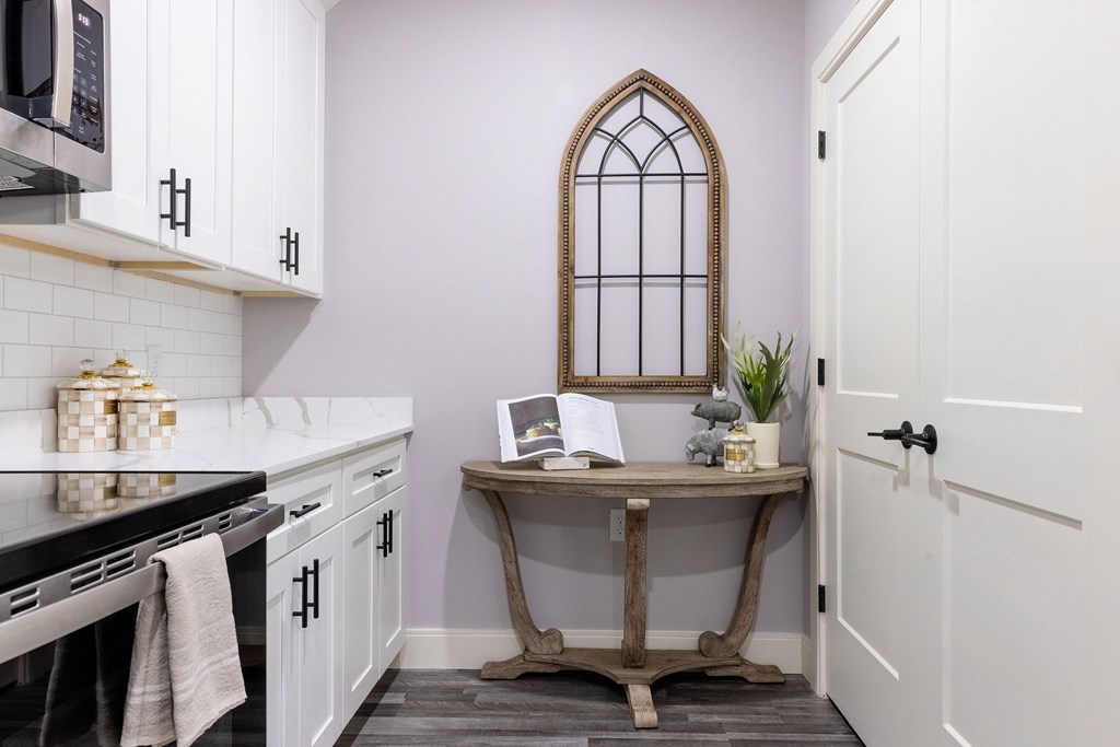 A kitchen with a table and a window.