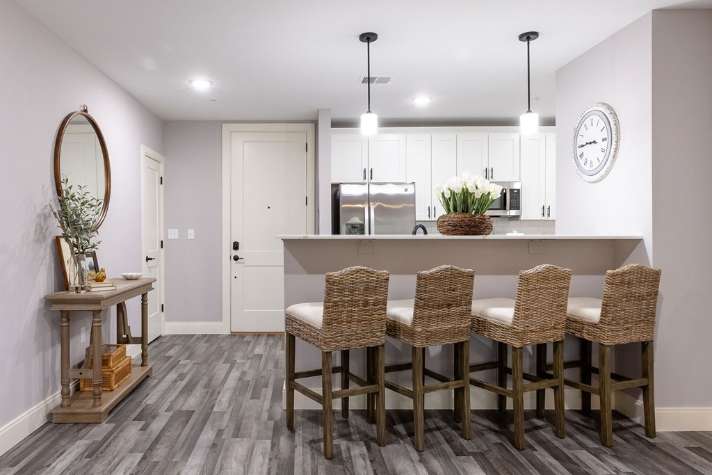 A kitchen with a dining table and chairs.