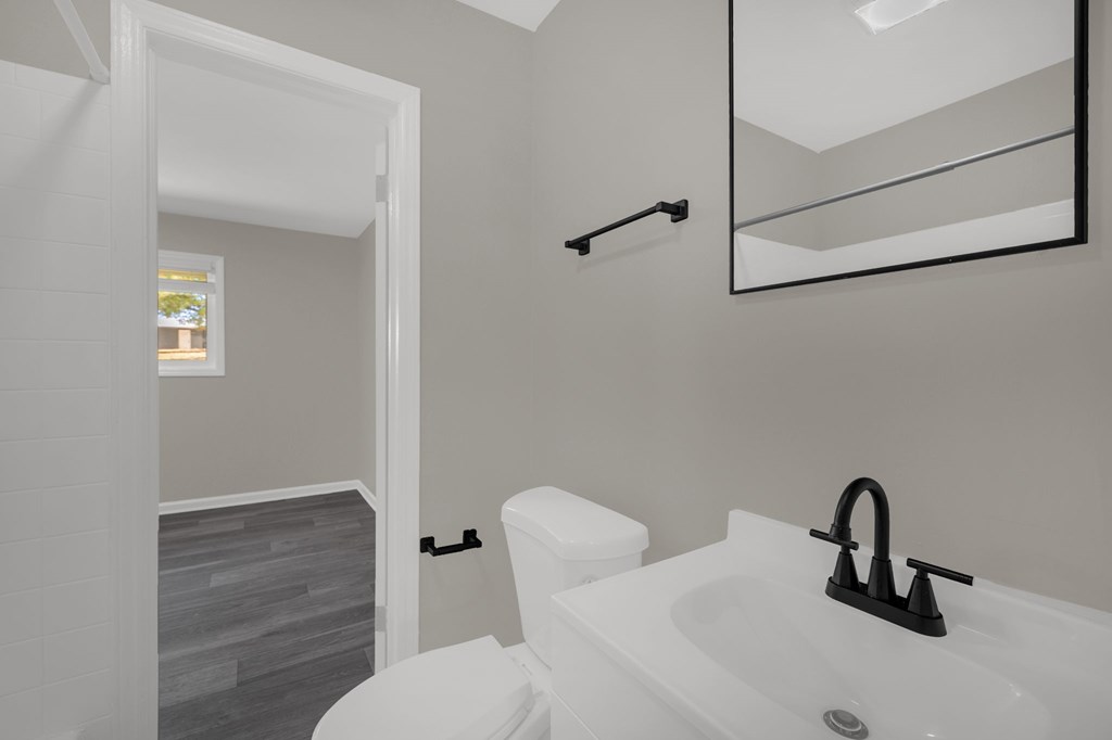 A white bathroom with a toilet and sink.