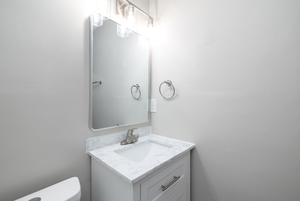 a small bathroom with a sink and a mirror