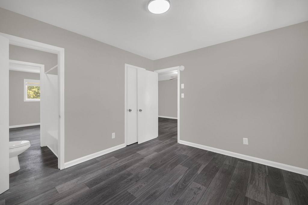 A room with a wooden floor and white walls.