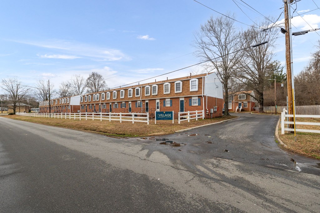 a large red brick building on the side of a road