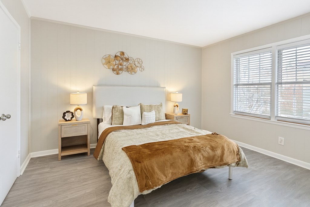 A bedroom with a large bed and a chandelier.