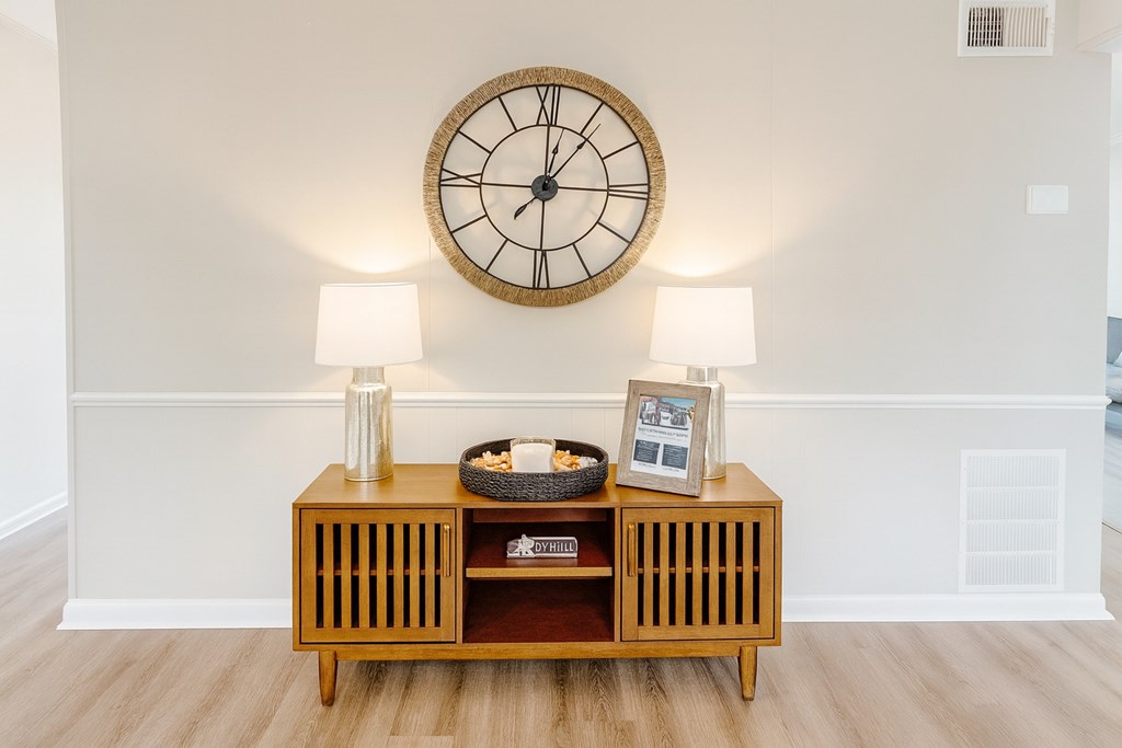A wooden shelf with a clock above it.