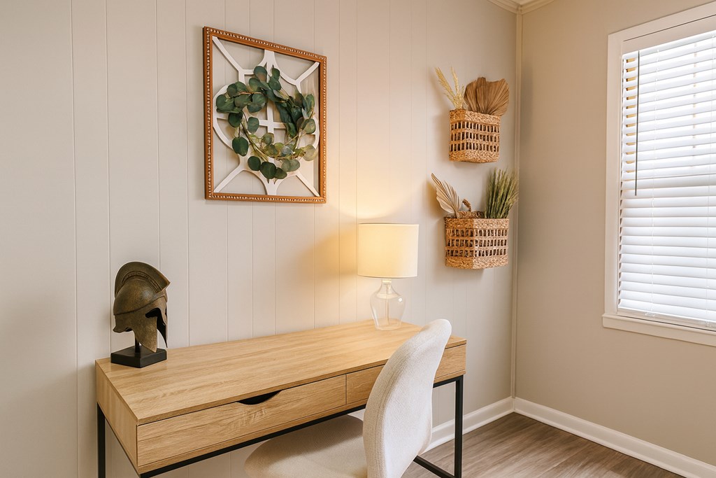 A desk with a lamp and a plant on it.