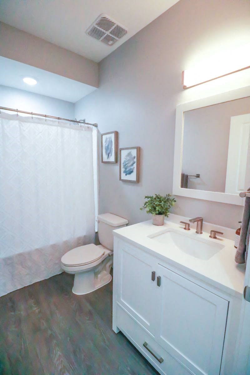 a bathroom with a white sink and a toilet