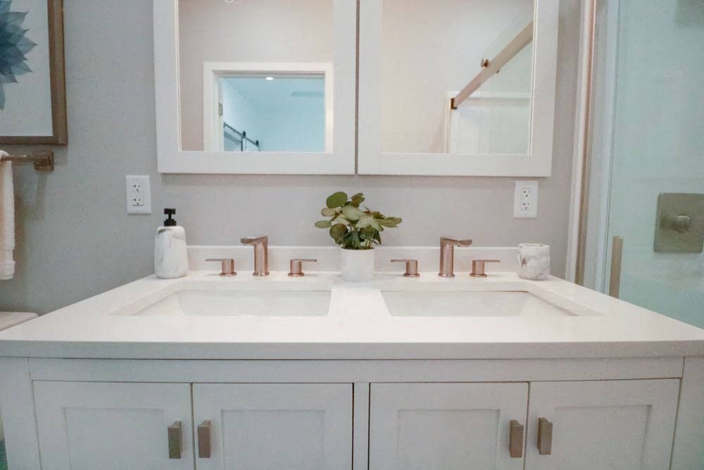 a white bathroom with a sink and a mirror