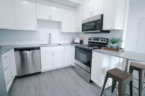 a kitchen with stainless steel appliances and white cabinets