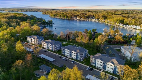 A bird's eye view of a residential area with a river in the background.
