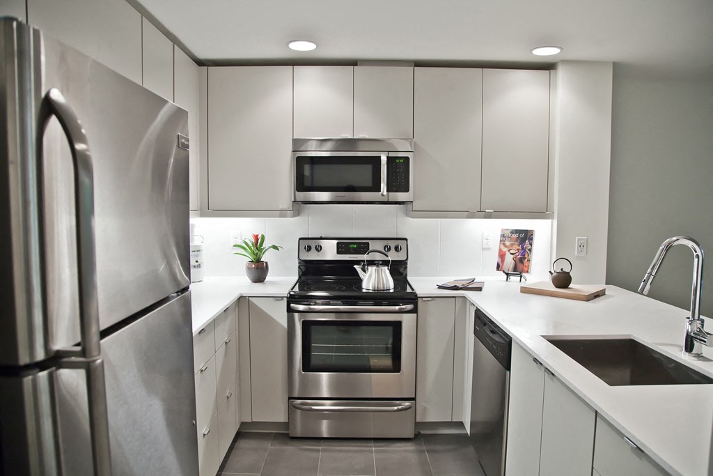 a kitchen with stainless steel appliances and white cabinets