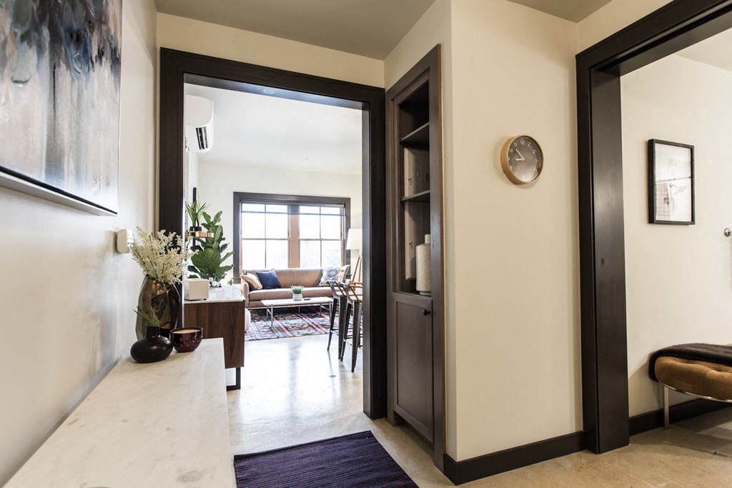 a hallway with a door to a living room and a dining room