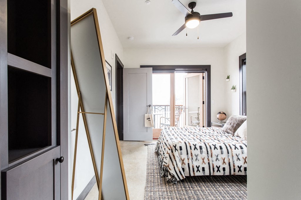 a bedroom with a bed and a ceiling fan