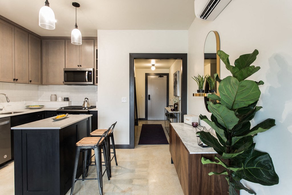 a kitchen with a long counter top and a sink