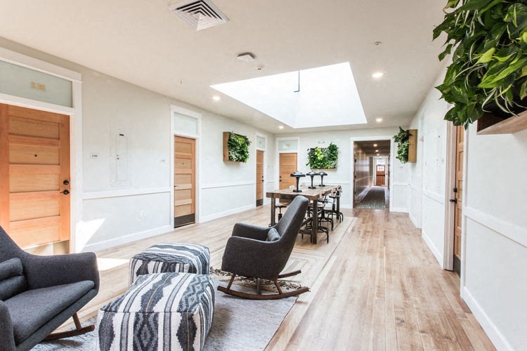 a living room and dining room with chairs and a table