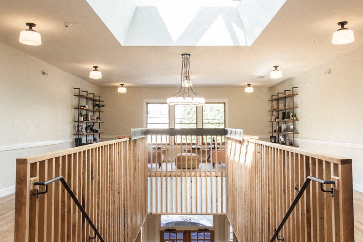 a view of a dining room from the top of a staircase