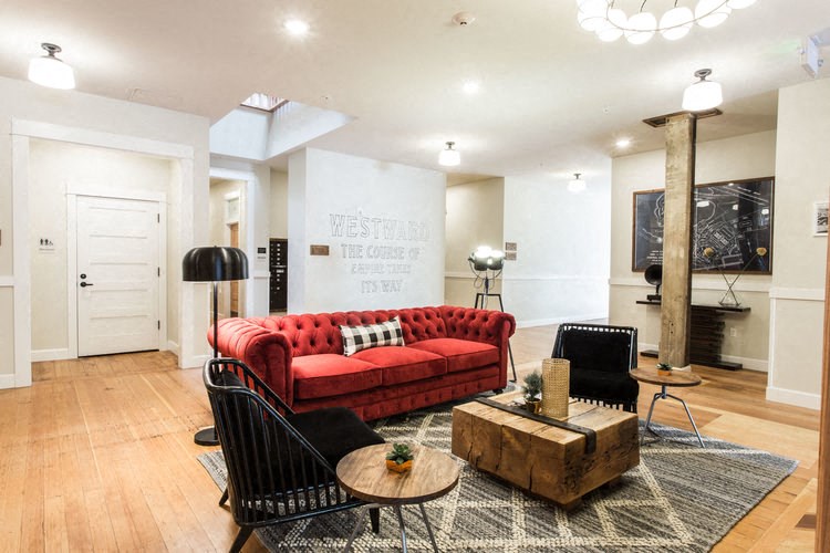 a living room with a red couch and a table