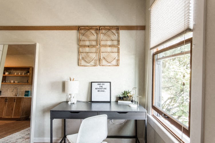 a home office with a desk and a window